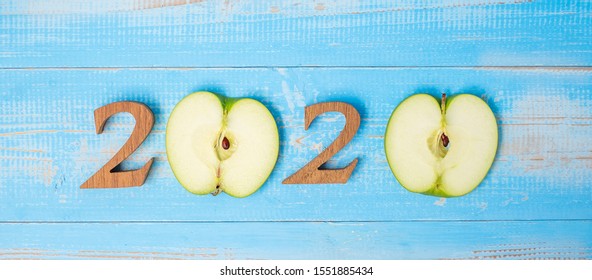 2020 Happy New Year And New You With Green Apple On Blue Wood Background. Goals, Healthy, Healthcare, Resolution, Time To New Start, Sport, Fitness And Dieting Concept.