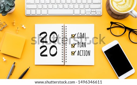 2020 new year goal,plan,action text on notepad with office accessories.Business motivation,inspiration concepts ideas