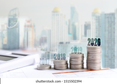 2020 New Year On Growing Up Money Coin Stack For Investment.  Economic And Business Growth In 2020, Planning Financial Report For Investor Real Estate Property Business, City Background. 