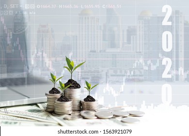 2020 New Year On Growing Up Money Coin Stack For Investment.  Economic And Business Growth In 2020, Planning Financial Report For Investor Real Estate Business, City Background. 