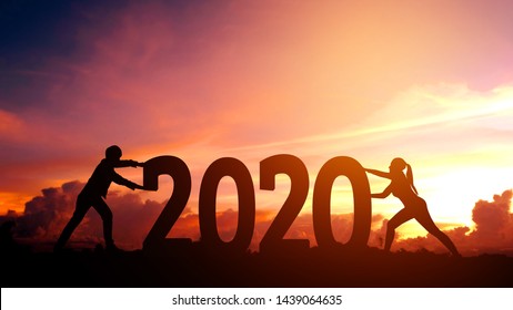 2020 Newyear  Couple Tries To Push Number Of 2020 Happy New Year Concept