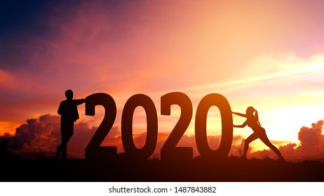 2020 Newyear  Couple Tries To Push Number Of 2020 Happy New Year Concept