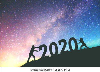 2020 Newyear  Couple Tries To Push Number Of 2020 Happy New Year Background On  The Milky Way Galaxy 