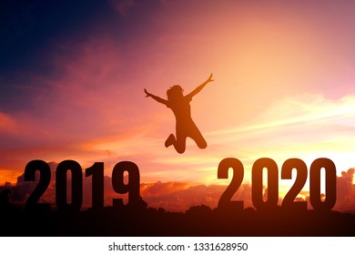 2020 Newyear Silhouette Young Woman Jumping To Happy New Year Concept.