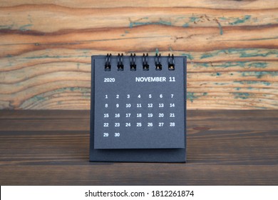 2020 NOVEMBER. Black paper calendar on a wooden table. Time planning, day counting and holidays