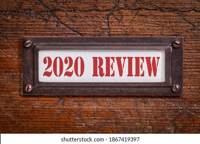 2020 review - a label on grunge wooden file cabinet. A passing year evaluation, summary and review concept.