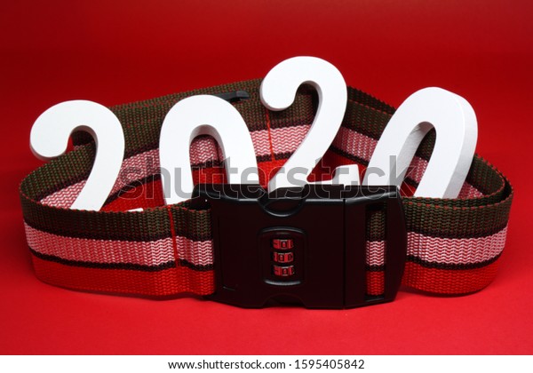 2020 with Safety Security belt on\
red background - Safe money investment , Safe Travel  concept\
