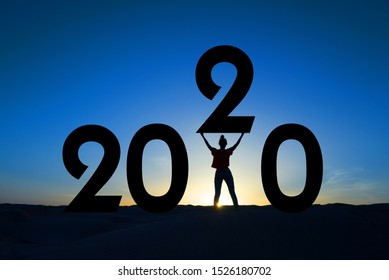 2020, silhouette of a woman standing in the sunrise, women empowerment, feminist new year holiday greeting card