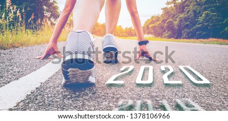 2020  symbolises number the Athletic starting to change new year, Start of people running on a street road with sunset light.Goal of Success the winner