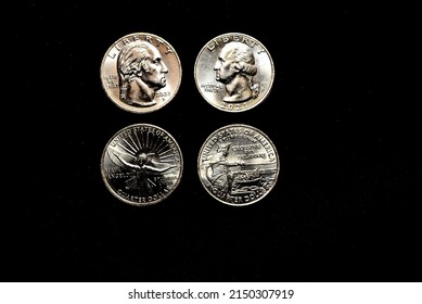 2021 and 2022 United State Quarters showing obverse and reverse of each coin on black background. The silver color coins are Cupro-Nickel. Make of 8.33 percent nickel balance of the metal is copper.