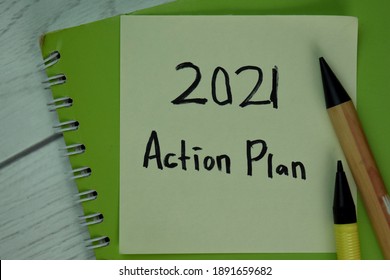 2021 Action Plan Write On Sticky Notes Isolated On Wooden Table.