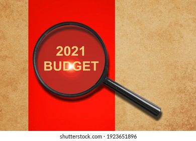 2021 Budget Concept Through Magnifier On Old Paper With Red Vertical Line Background.