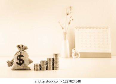 2021 Calendar schedule for long term fund invest, pension saving, financial concept : US dollar bag, coins and clock, depicts time value of money, investing ways to beat high inflation with growth