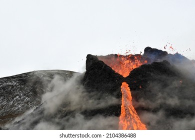 The 2021 Eruption At Fagradalsfjall, Iceland. Lava Flowing From Volcanic Vent  Crater, With Ash Rising Due To A Rock Fall Collapse. 