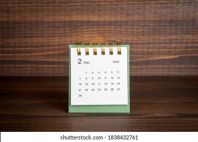 2021 February. Time planning, business, day counting and holidays. Paper calendar on a wooden table - Shutterstock ID 1838432761