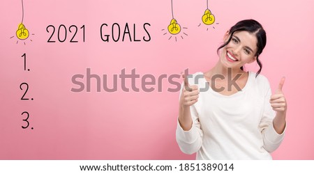 2021 goals with happy young woman giving thumbs up