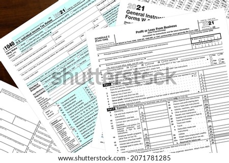 2021 IRS tax forms on a desktop.