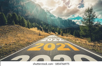 2021 New Year road trip travel and future vision concept . Nature landscape with highway road leading forward to happy new year celebration in the beginning of 2021 for fresh and successful start . - Shutterstock ID 1854766975