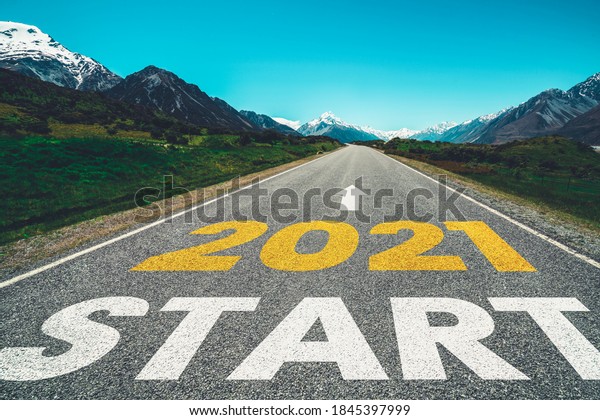 2021 New Year road trip travel and future vision\
concept . Nature landscape with highway road leading forward to\
happy new year celebration in the beginning of 2021 for fresh and\
successful start .