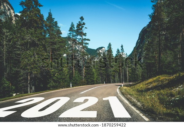 2021 New Year road trip travel and future vision
concept . Nature landscape with highway road leading forward to
happy new year celebration in the beginning of 2021 for fresh and
successful start .