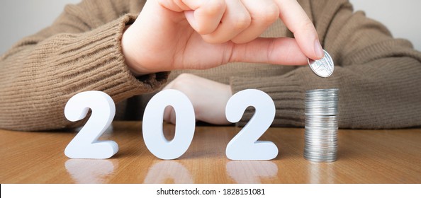 2021 New Year Saving Money And Financial Planning Concept. Female Hands Putting Coins On Stack With Number 2021. Creative Idea For Business Growth, Tax Payment, Investment And Banking.