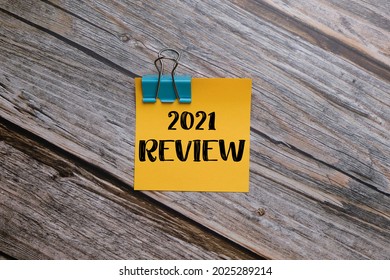 2021 Review Written On Adhesive Notes With Wooden Background.