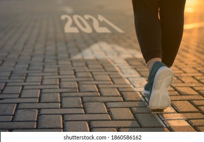 2021 start goal forward business concept. New Year 2021 movement to success, victory, career change. feet on arrow in sunlight - Shutterstock ID 1860586162