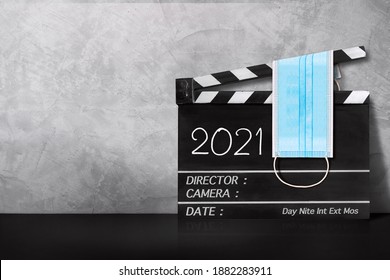 2021 Text Title On Film Slate And Surgical Mask.COVID-19,Coronavirus Movie Concept.