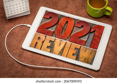 2021 year review banner - annual review or summary of the recent year - word abstract in letterpress wood type blocks on a digital tablet with a cup of coffee