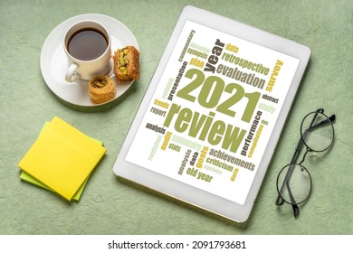 2021 year review word cloud on a digital  tablet with a cup of coffee, end of year business analysis concept