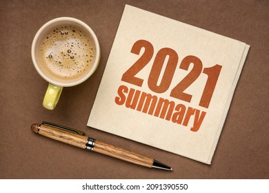 2021 year summary text on a napkin with a cup of coffee, end of year business concept