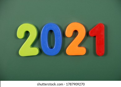 2021 year written in bright plastic magnetic letters stuck on a magnetic board