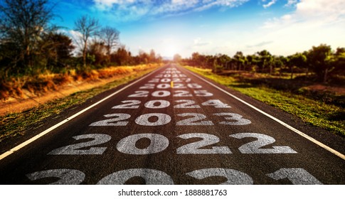2021-2025 written on highway road in the middle of empty asphalt road and beautiful blue sky. Concept for vision 2021-2025. - Shutterstock ID 1888881763