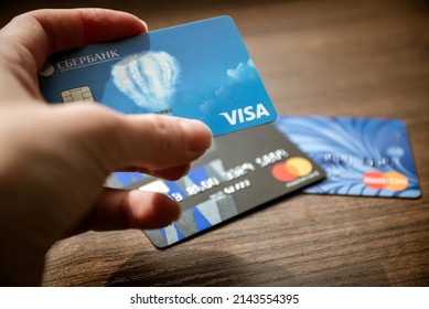 2022, April, Moscow, Russia - Credit Card Holded By Hand, Credit Cards Blurred On Background