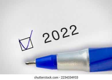2022 Done concept. Check mark with hand drawn V mark in a box near the text 2022 year.