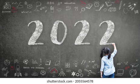 2022 Happy new year school class academic calendar with student kid's hand drawing greeting on teacher black chalkboard for educational celebration, back to school, STEM education classroom schedule