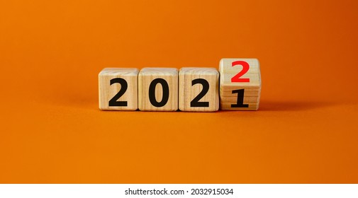 2022 happy new year symbol. Turned a cube, symbolize the change from 2021 to the new year 2022. Beautiful orange background. Copy space. Business and 2022 happy new year concept. - Shutterstock ID 2032915034