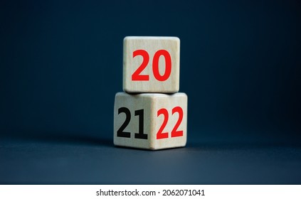 2022 happy new year symbol. Turned cubes, symbolize the change from 2021 to the new year 2022. Beautiful grey table, grey background. Copy space. Business and 2022 happy new year concept.