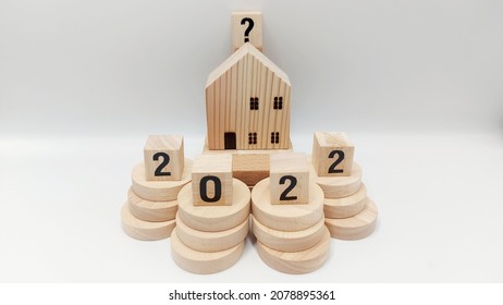 2022 Housing Market Represented By Staging Of Wooden Blocks And Discs