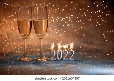 2022 New Year. Happy new year 2022 greeting card. Champagne glasses on glitter background - Shutterstock ID 2061604307
