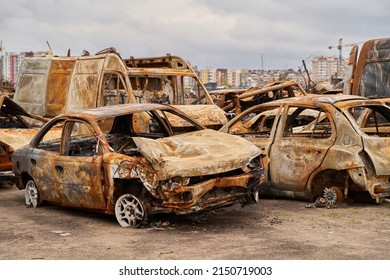 2022 Russian Invasion Of Ukraine War Torn City Destroyed Car Burn Out. Russia War Damage Building Destruction City War Ruins City Damage Car. Disaster Area. Cars Beaten By Shrapnel And Burnt