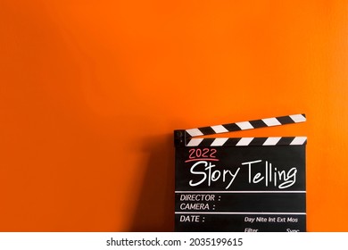 2022 story.hand writing on film slate or movie clapboard for the filmmaker.storytelling concept on multicolor background