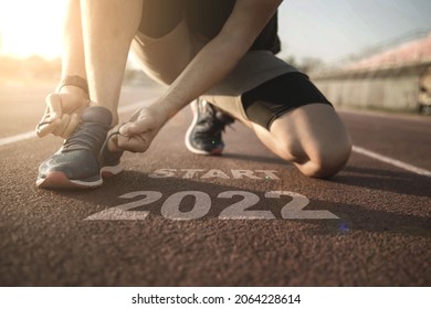 2022 symbolises the start into the new year.Start of people running on street,with sunset light.Goal of Success	 - Shutterstock ID 2064228614