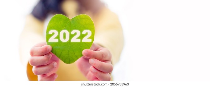 2022 text symbol on kid hands green leaf eco go green, creative eco environment investment fund, climate change green nature innovation business trend.Happy New Year ecology plant.csr esg. environment