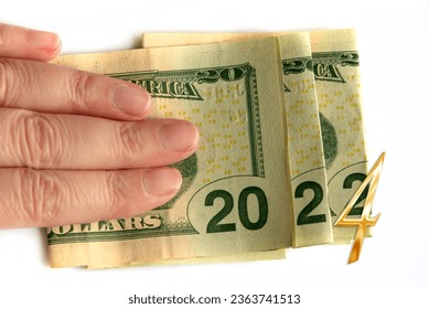 2022 written with dollars bank notes in a hand isolated on white background, new year greetings money concept