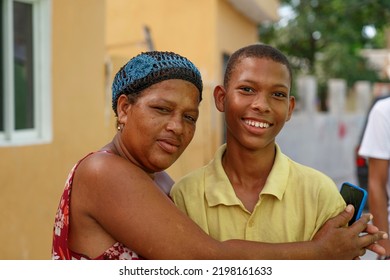 2022.09.01. Dominican Republic. Veron. Mother Hugging Her Teenage Son.