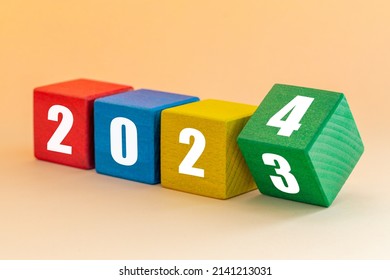 2023 to 2024, White numbers on joyfully colored blocks, Merry Christmas and a Happy New Year, Apricot background  - Shutterstock ID 2141213031