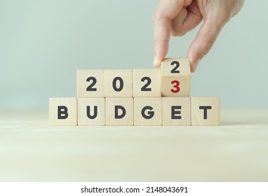 2023 Budget planning and allocation concept.  Hand flips wooden cube and changes the inscription "BUDGET 2022" to "BUDGET 2023" with grey  background, copy space. Use for banner and presentation. - Shutterstock ID 2148043691
