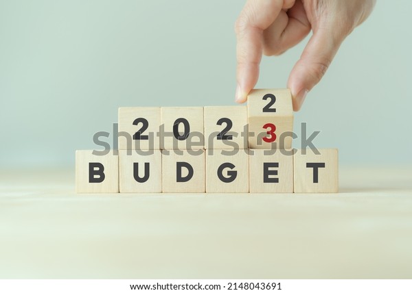 2023 Budget planning and allocation
concept.  Hand flips wooden cube and changes the inscription
