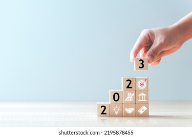 2023 Business development to success and growing growth concept.business strategy, Action plan, Goal and target, hand stack woods block step on table with icon about business strategy and Action plan.